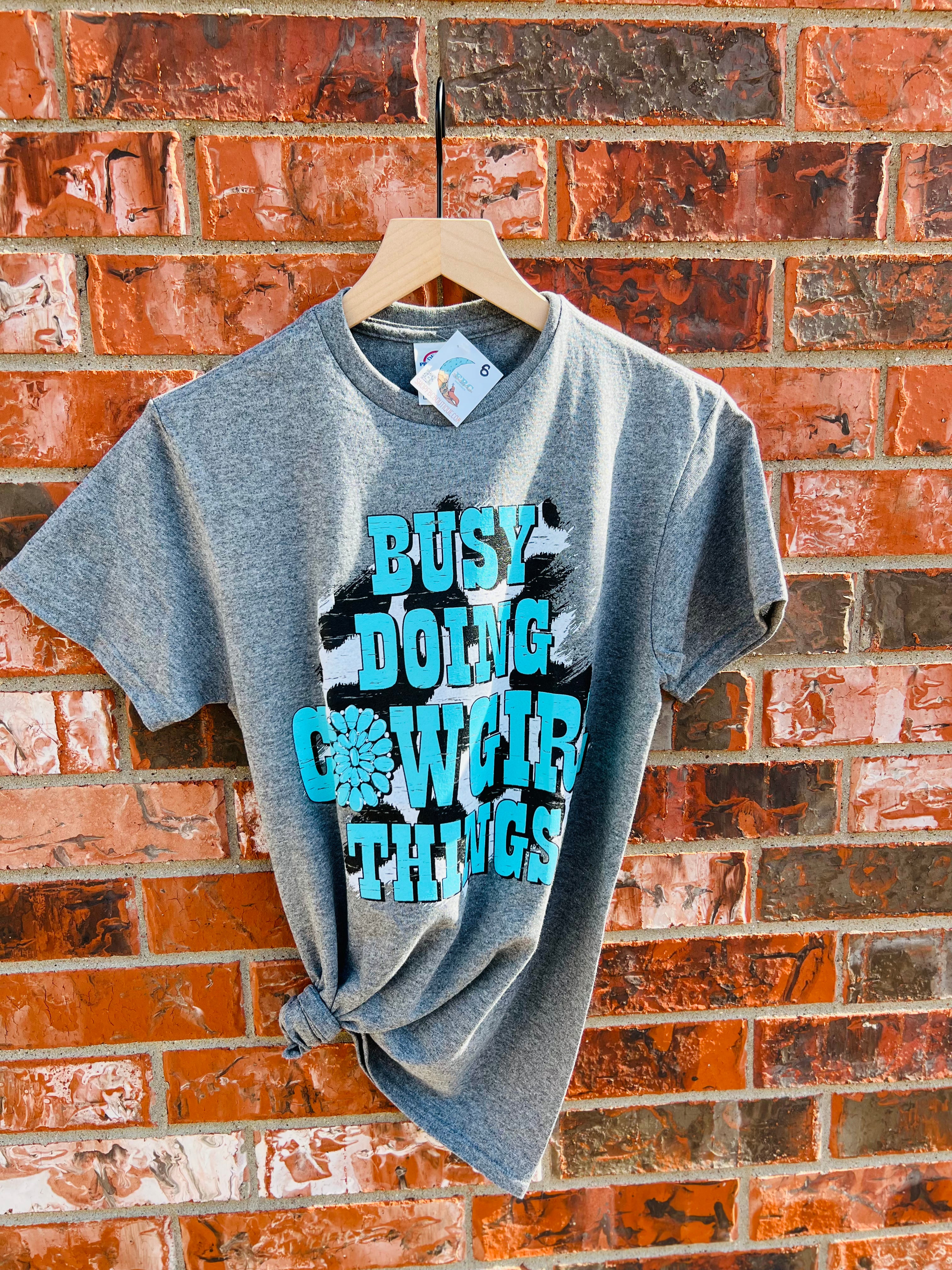 Busy Doing Cowgirl Things Cow Print Concho Comfy Tee