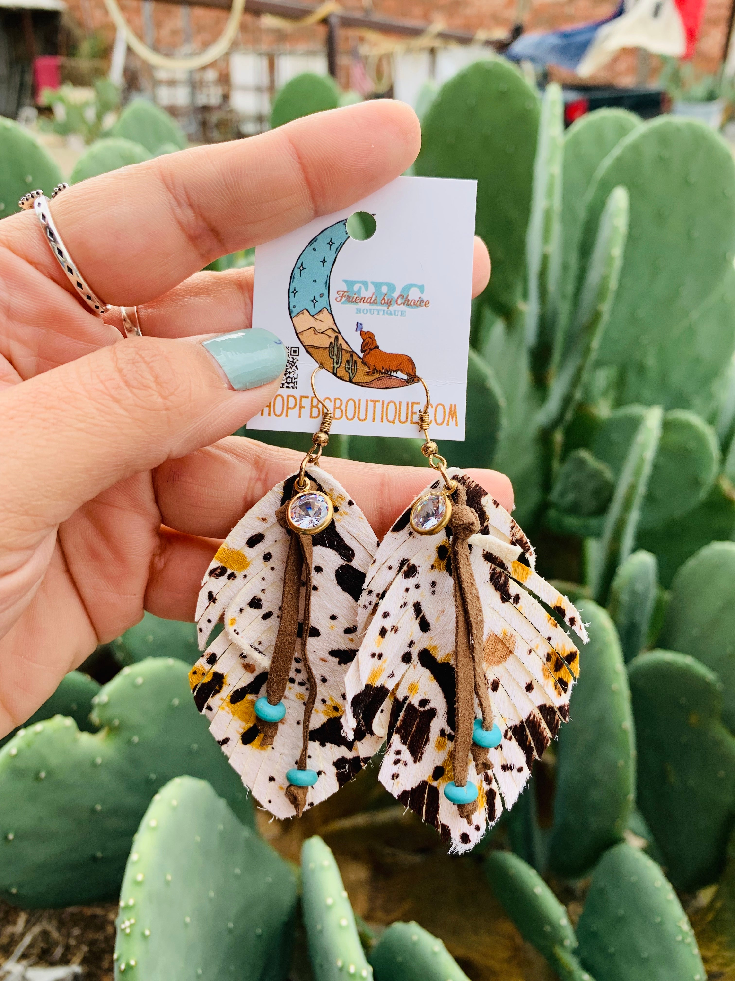 Coming Back To You Cream Cow Print Feather Teardrop Dangle Earrings